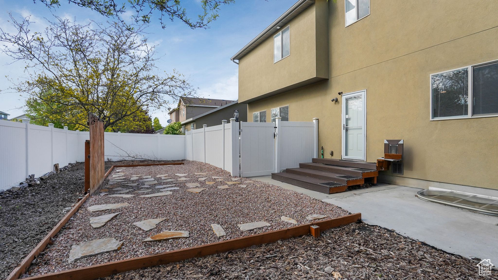 View of yard featuring a fenced backyard, a patio area, and a gate