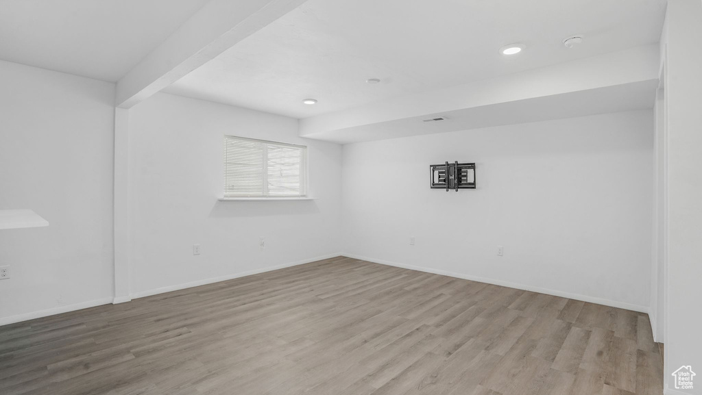 Empty room with recessed lighting, baseboards, and wood finished floors