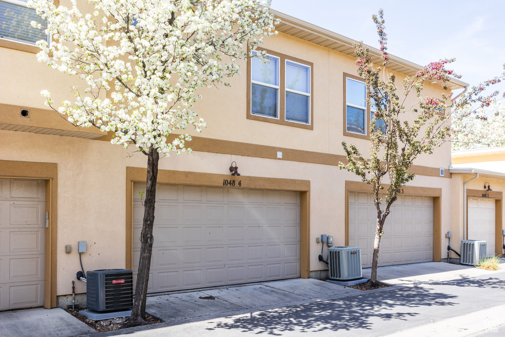 Exterior space with central AC unit and stucco siding