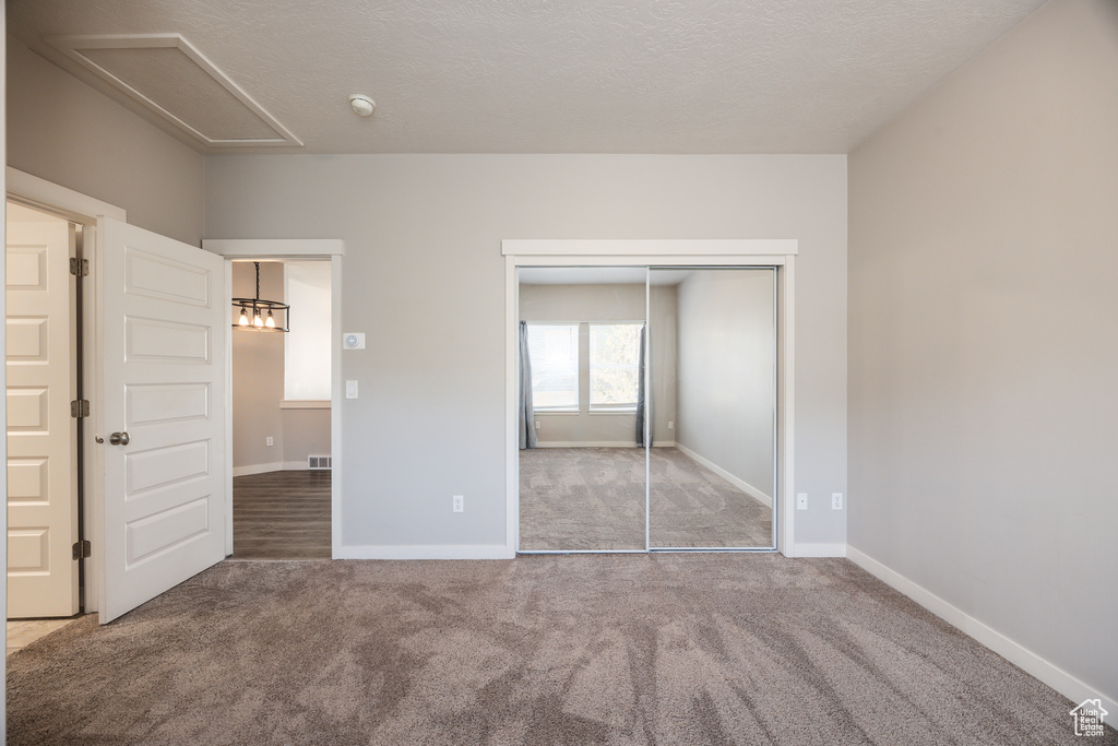 Unfurnished bedroom featuring carpet floors, baseboards, and visible vents