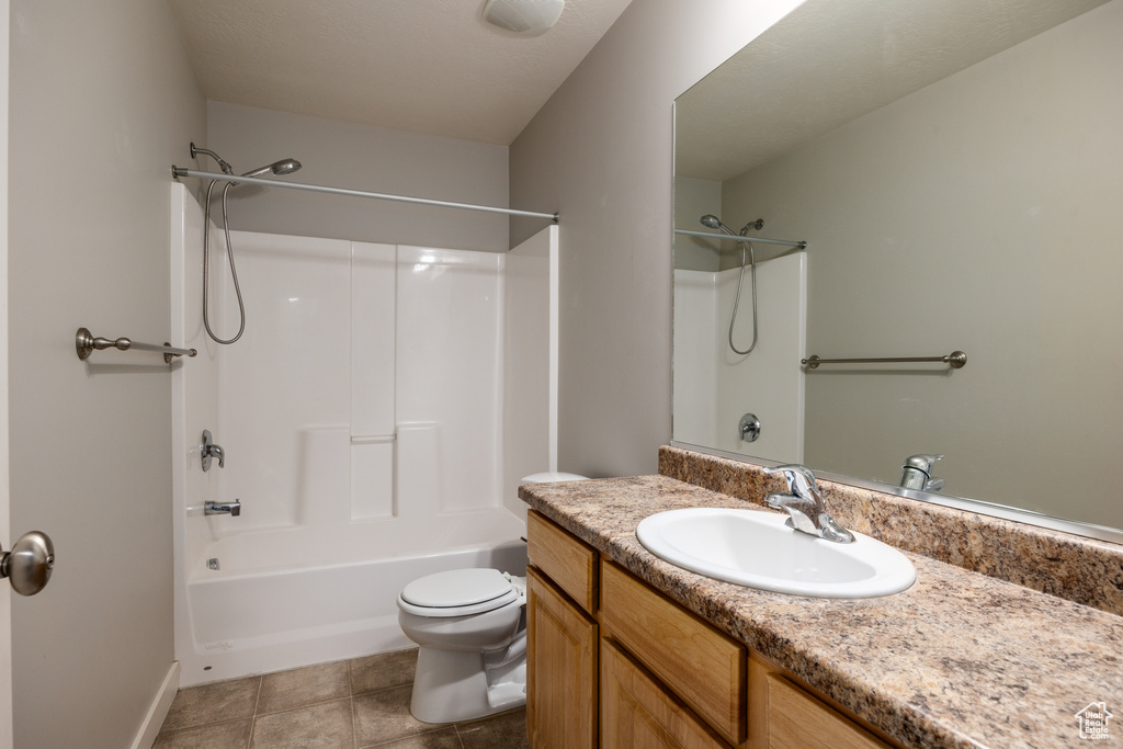 Full bathroom featuring visible vents, vanity, baseboards, toilet, and tub / shower combination