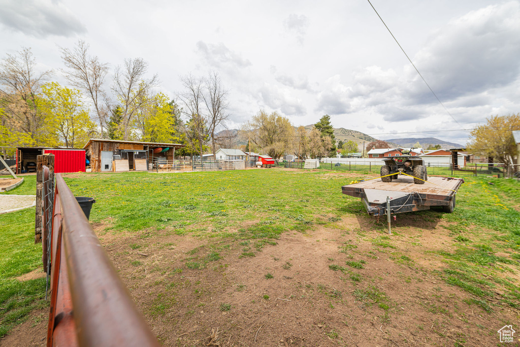 View of yard with fence and an outbuilding