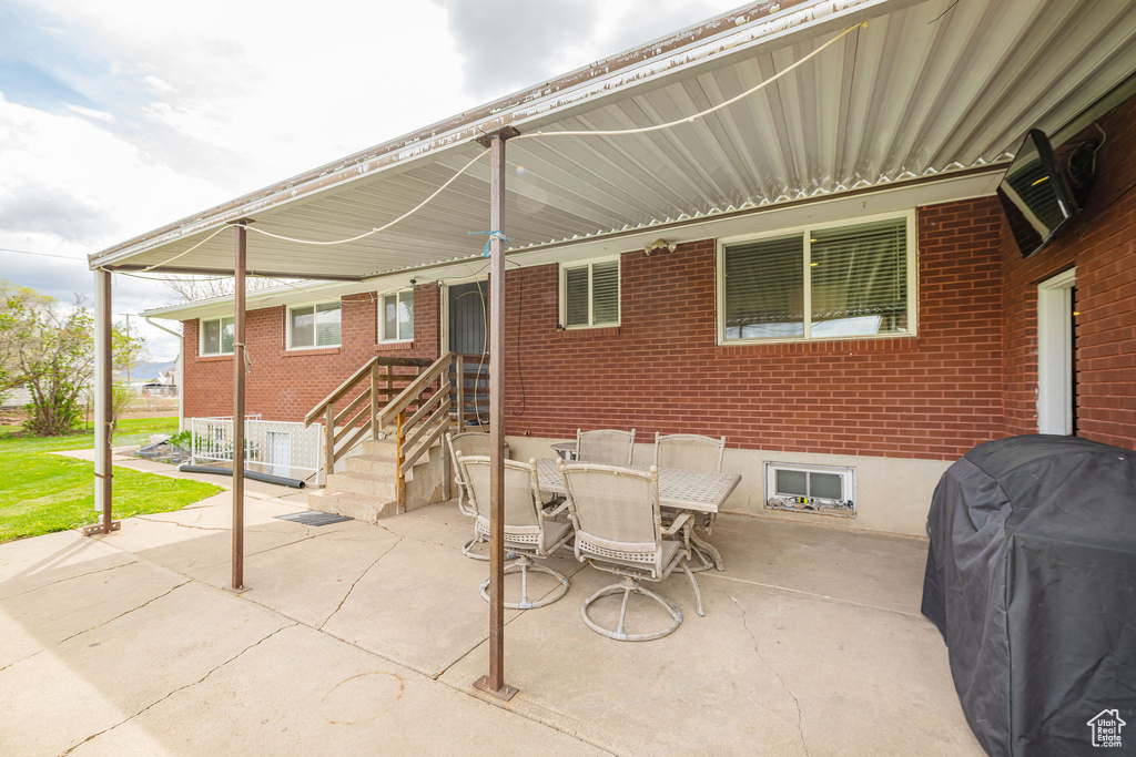 View of patio / terrace with outdoor dining space and a grill
