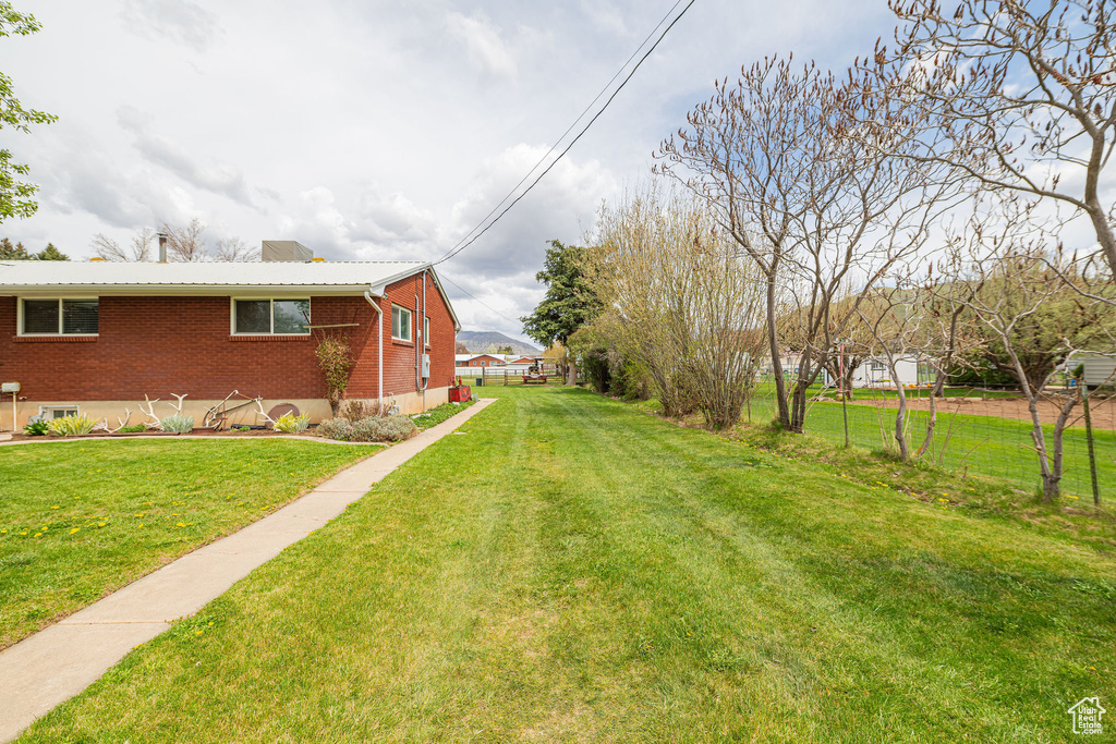 View of yard featuring fence