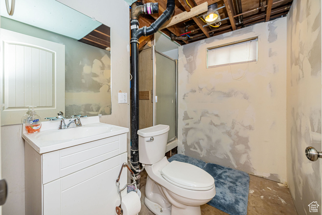 Full bath featuring toilet, walk in shower, and vanity
