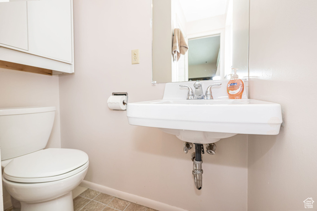 Bathroom featuring toilet and baseboards