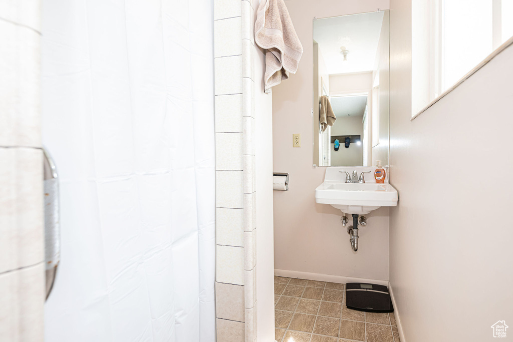 Bathroom featuring a sink and baseboards