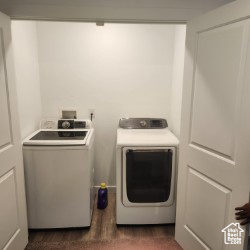 Washroom featuring separate washer and dryer and laundry area