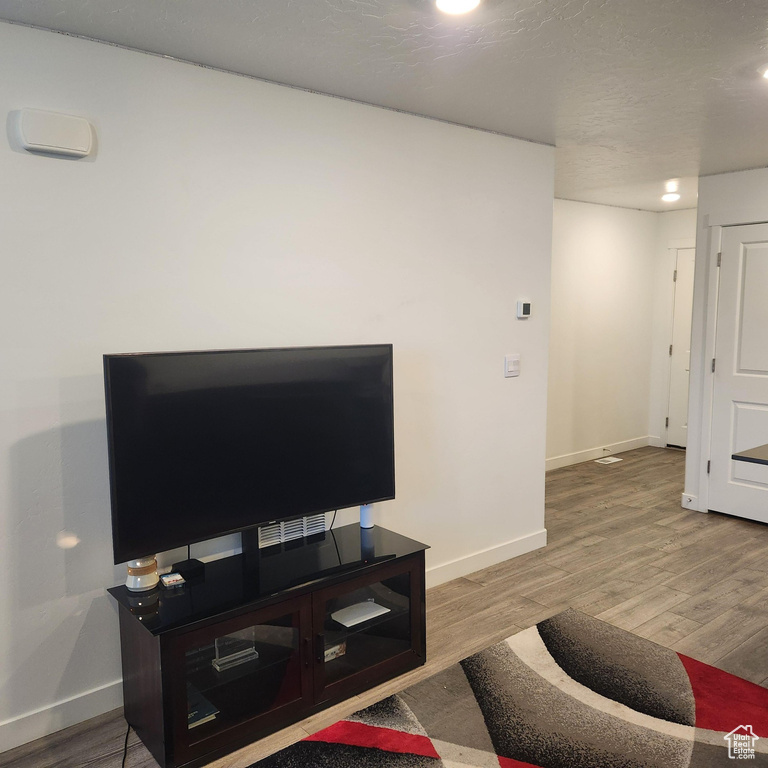 Living room featuring recessed lighting, baseboards, and wood finished floors