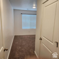 Carpeted spare room with baseboards