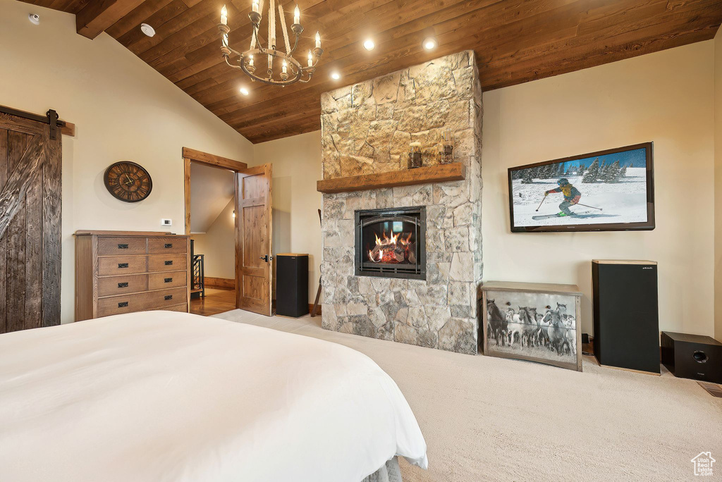 Bedroom featuring vaulted ceiling, an inviting chandelier, a fireplace, and wood ceiling