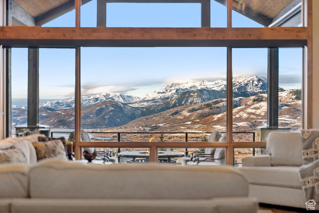 Living area with a mountain view and lofted ceiling
