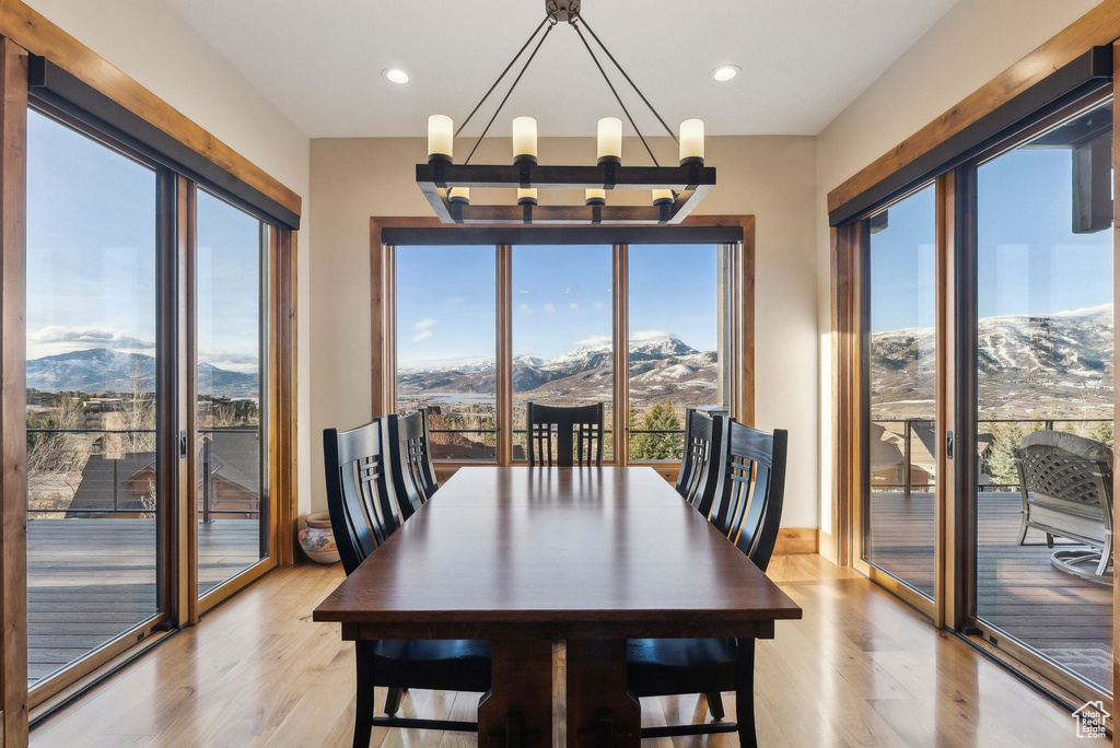 Dining room featuring a notable chandelier, a mountain view, and light wood finished floors