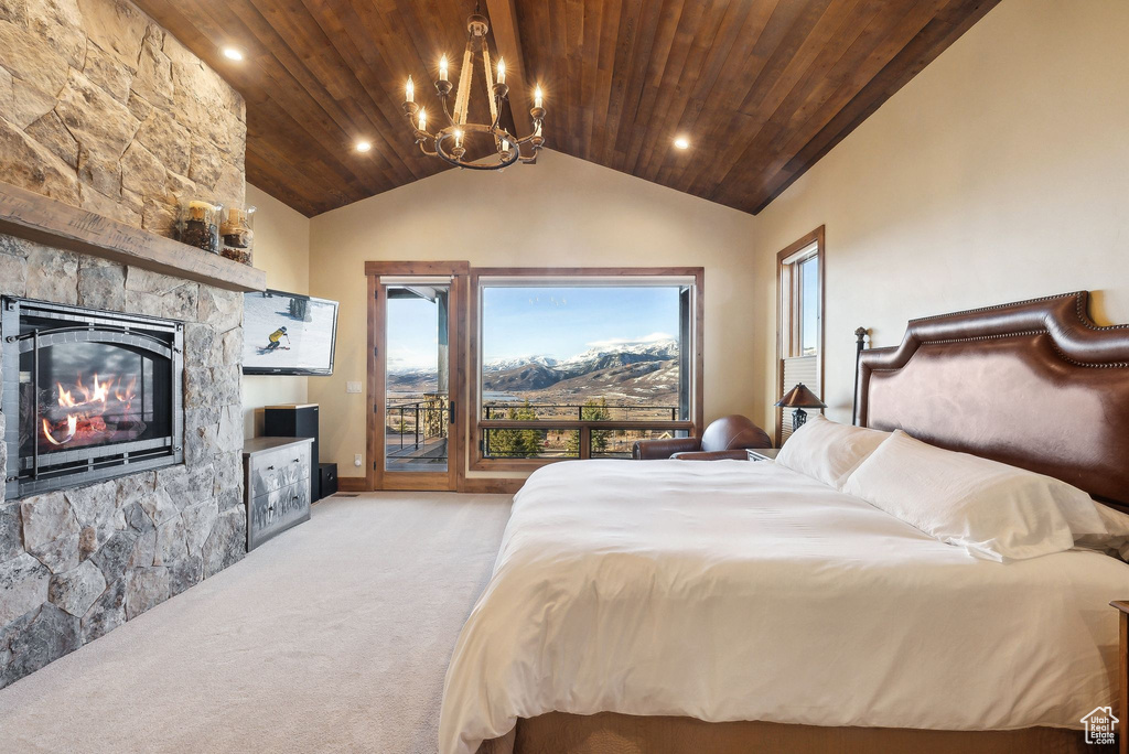 Carpeted bedroom featuring an inviting chandelier, a fireplace, access to outside, vaulted ceiling, and wood ceiling