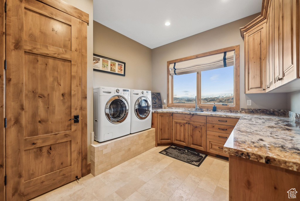 Laundry area featuring recessed lighting, a sink, cabinet space, and independent washer and dryer