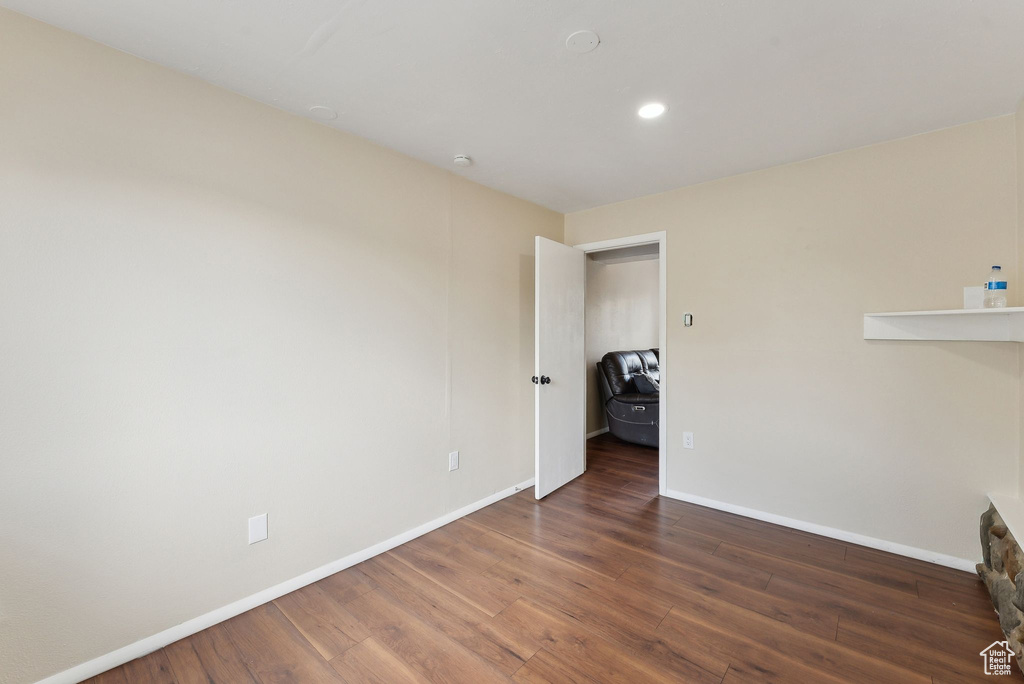 Unfurnished living room with baseboards, recessed lighting, and wood finished floors