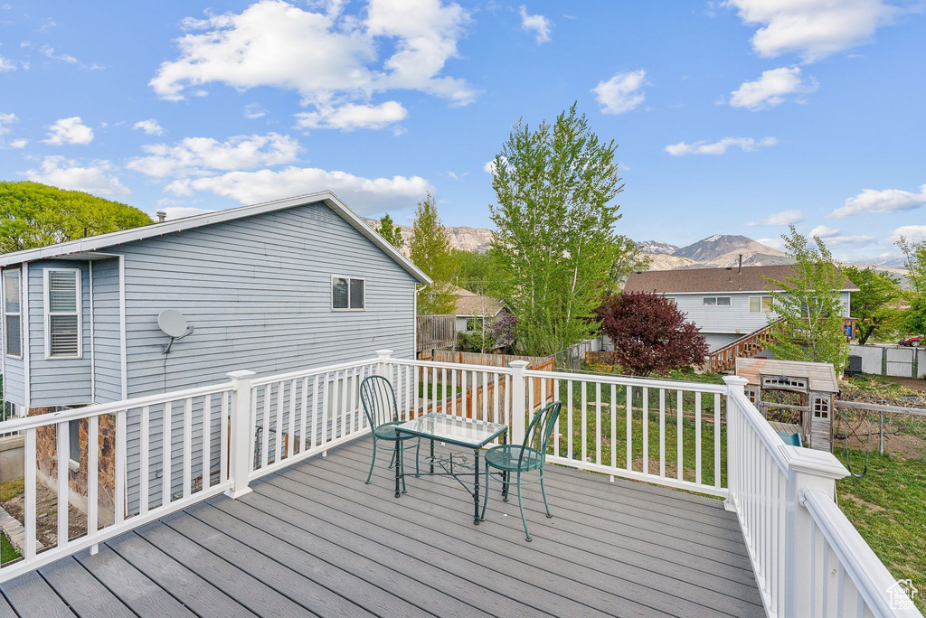 Deck with fence and a mountain view