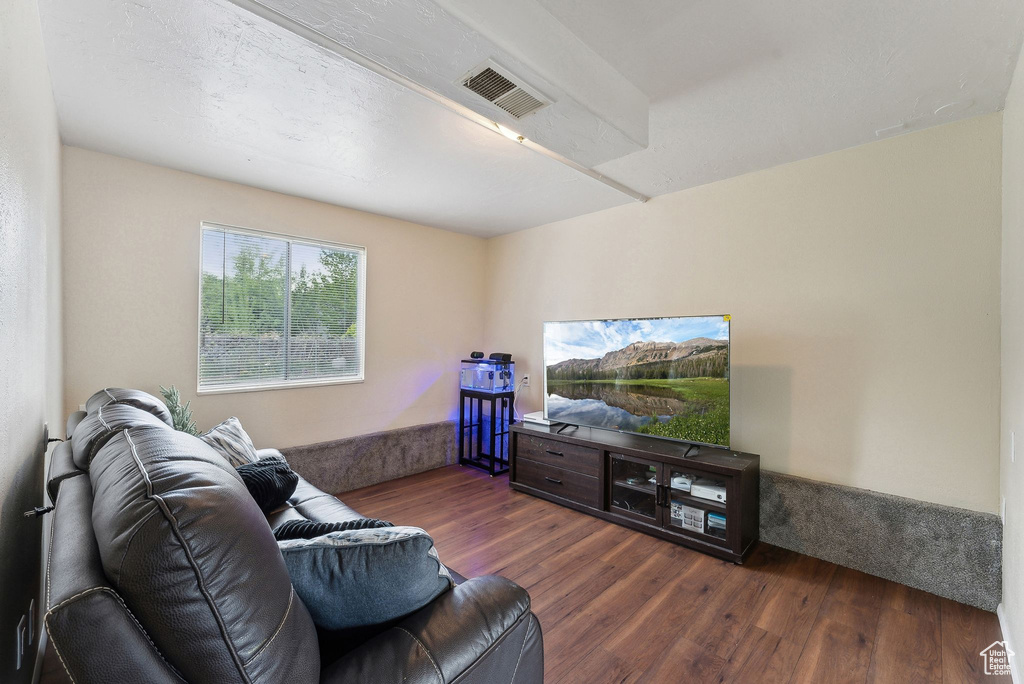 Living area featuring visible vents and wood finished floors