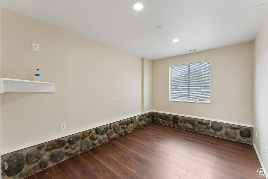 Empty room with recessed lighting, visible vents, and wood finished floors
