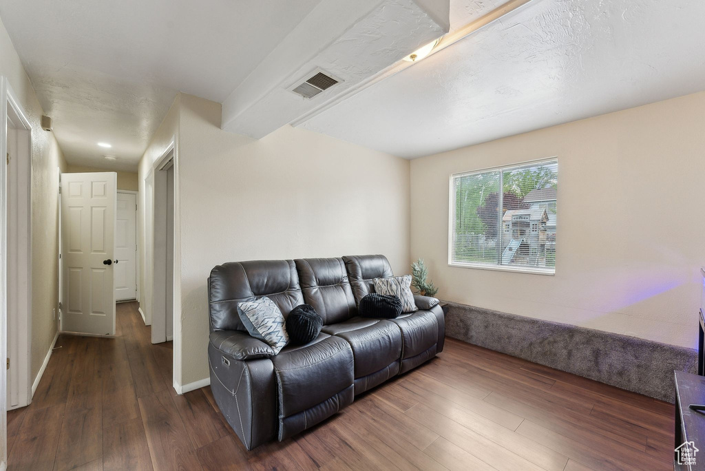 Living area with visible vents, baseboards, and wood finished floors
