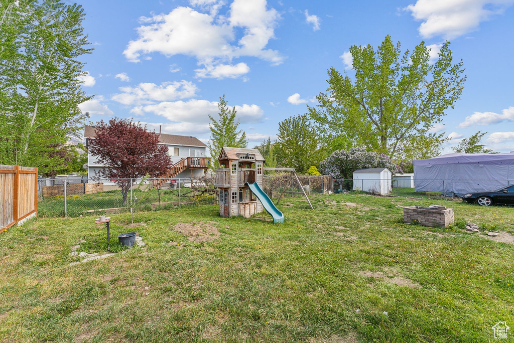 View of yard featuring a fenced backyard and a playground