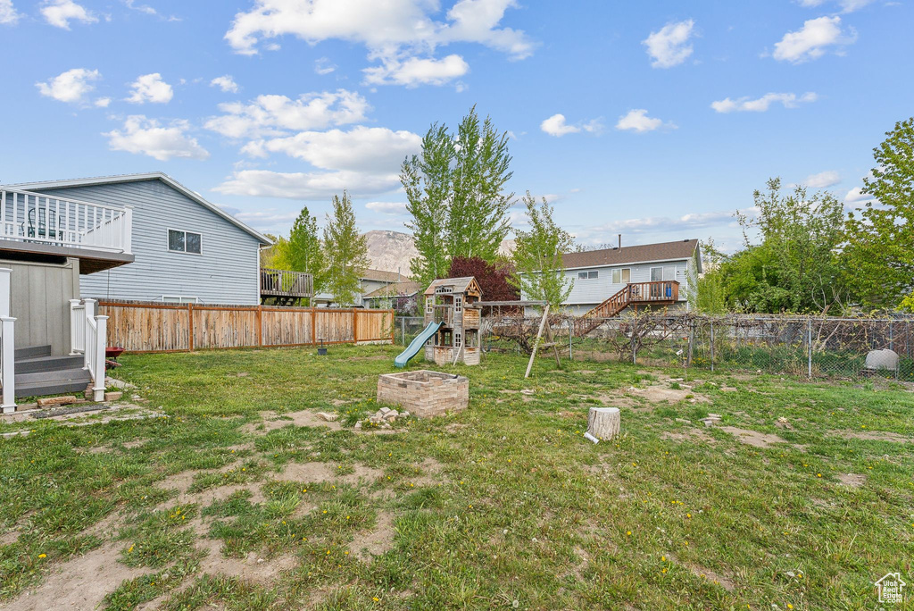 View of yard featuring a fenced backyard and a playground