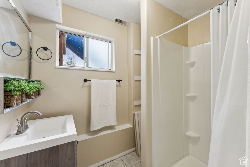 Bathroom with visible vents, a shower with curtain, and vanity