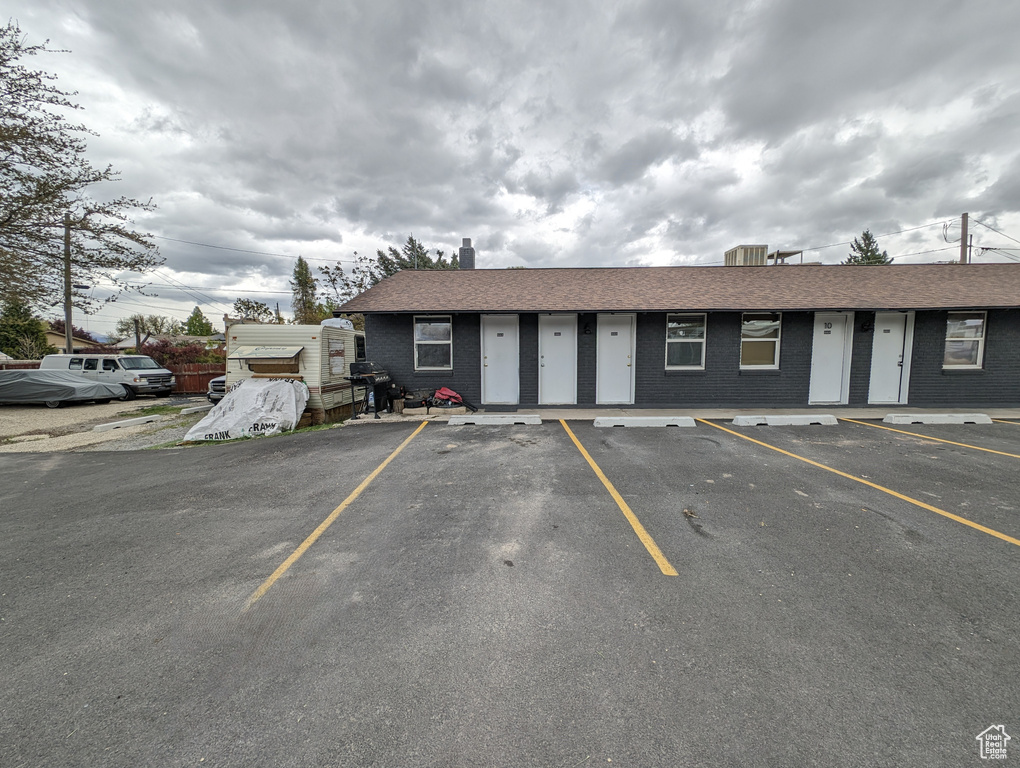 View of property with uncovered parking