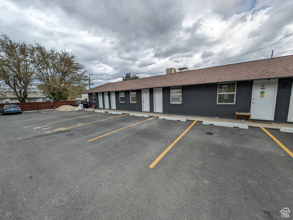 View of property with uncovered parking