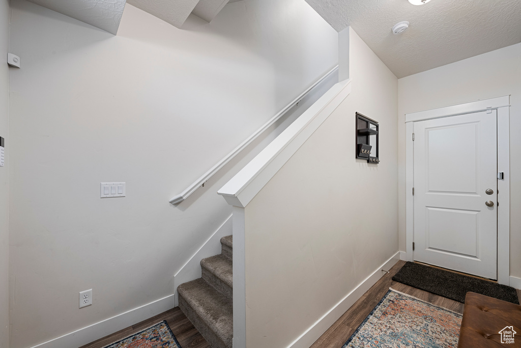 Interior space with baseboards and wood finished floors