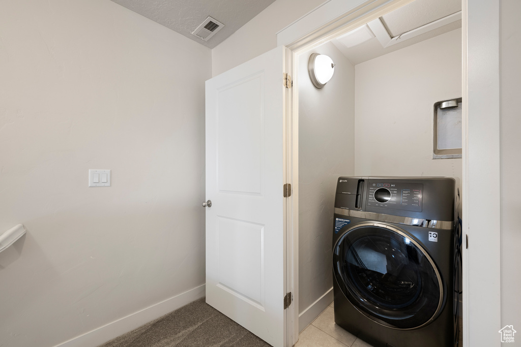 Laundry area with baseboards, laundry area, washer / clothes dryer, and visible vents