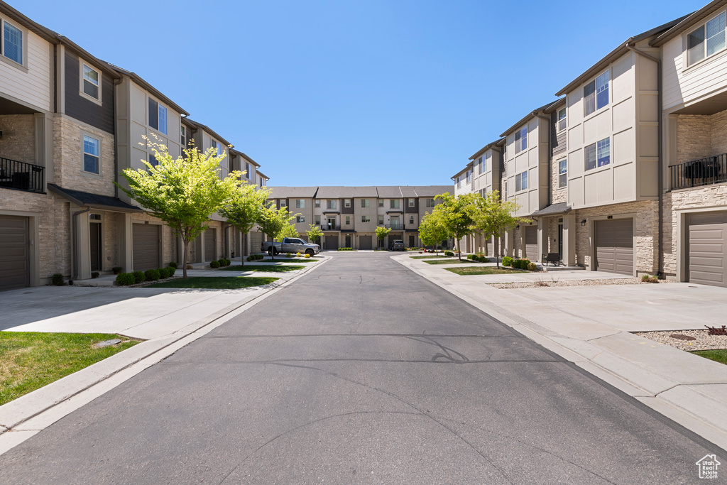 View of street with a residential view, sidewalks, and curbs