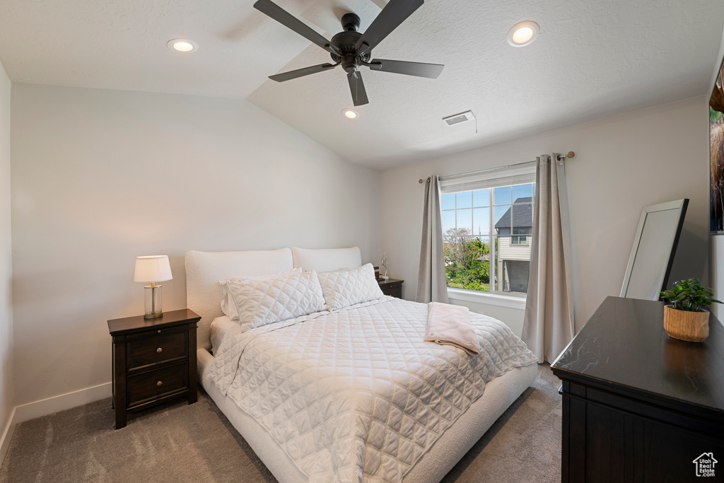 Carpeted bedroom with visible vents, recessed lighting, baseboards, a ceiling fan, and vaulted ceiling