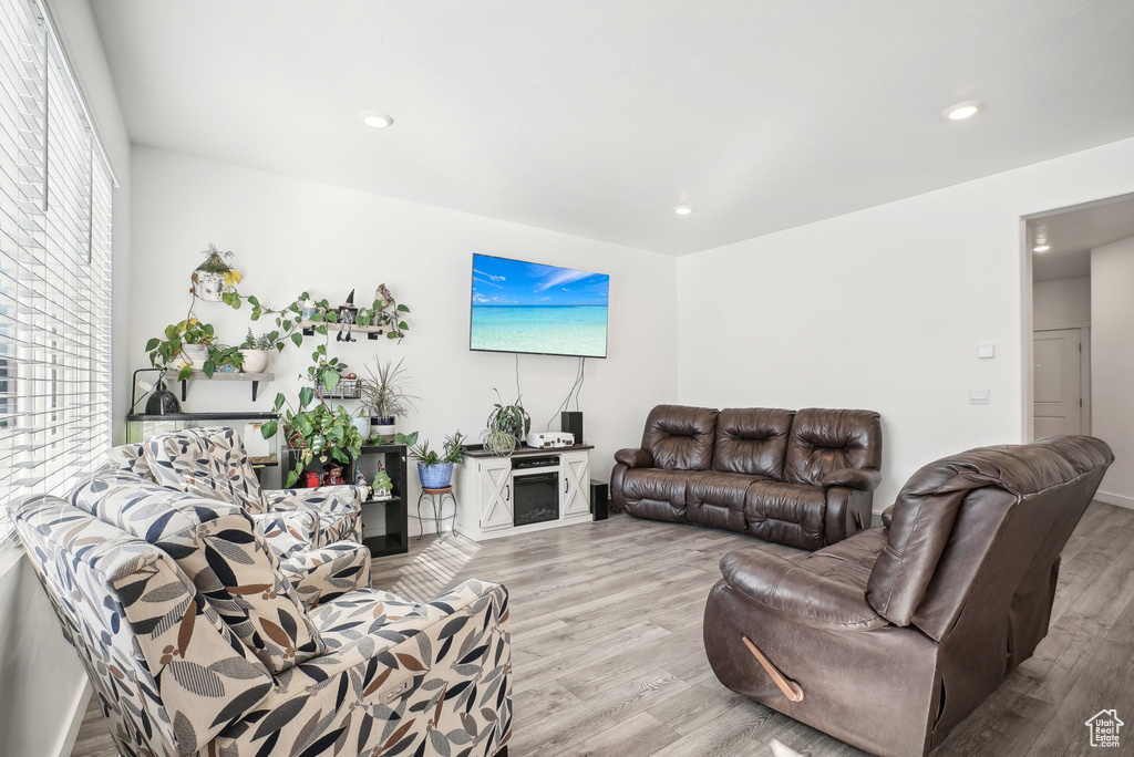 Living area featuring a fireplace, recessed lighting, and wood finished floors