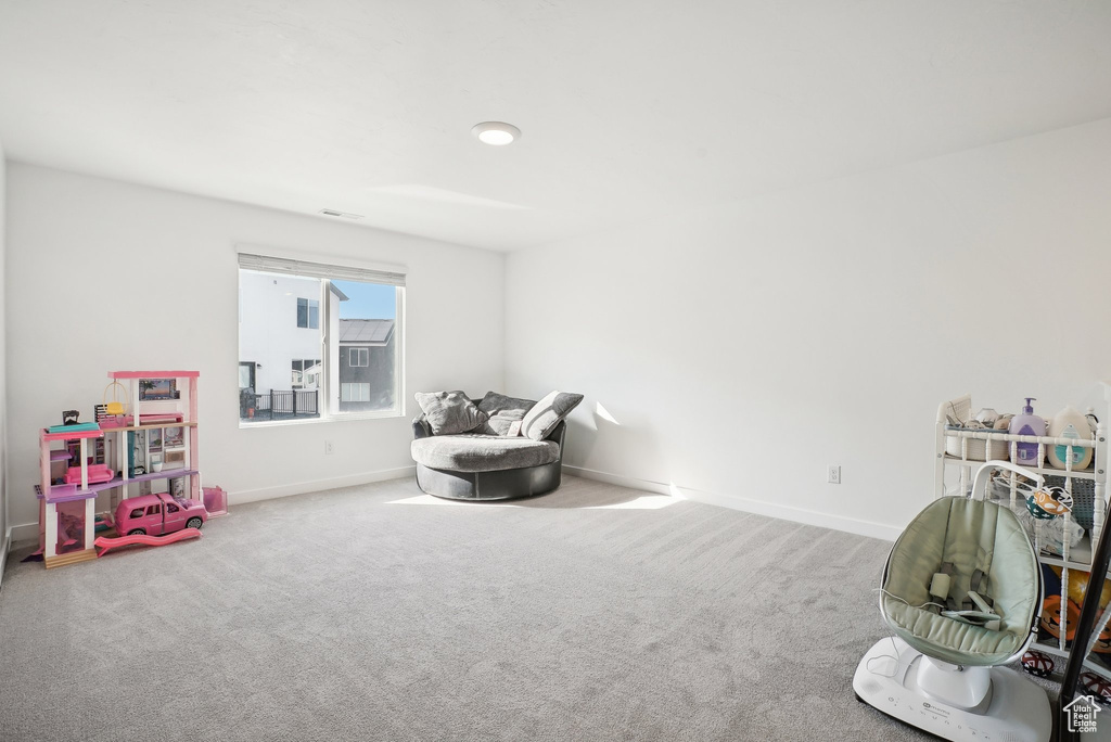 Playroom featuring carpet floors, baseboards, and visible vents