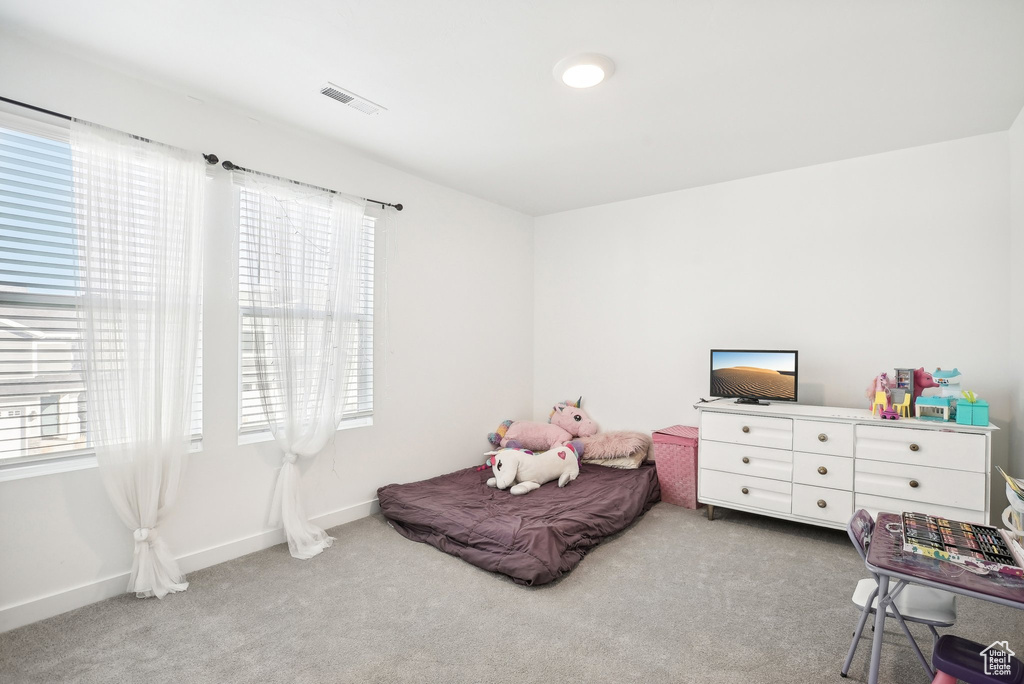 Bedroom with visible vents, carpet, baseboards, and multiple windows