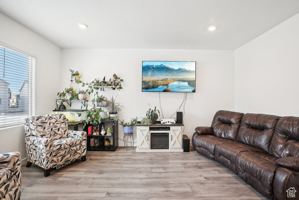 Living room with recessed lighting and light wood-style flooring