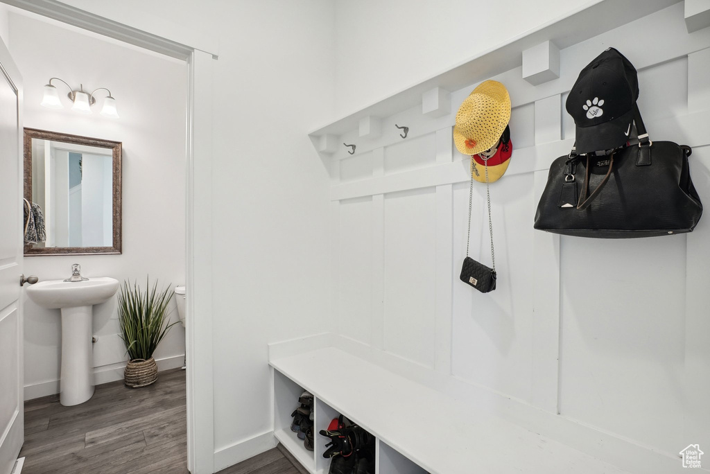 Mudroom featuring baseboards and wood finished floors