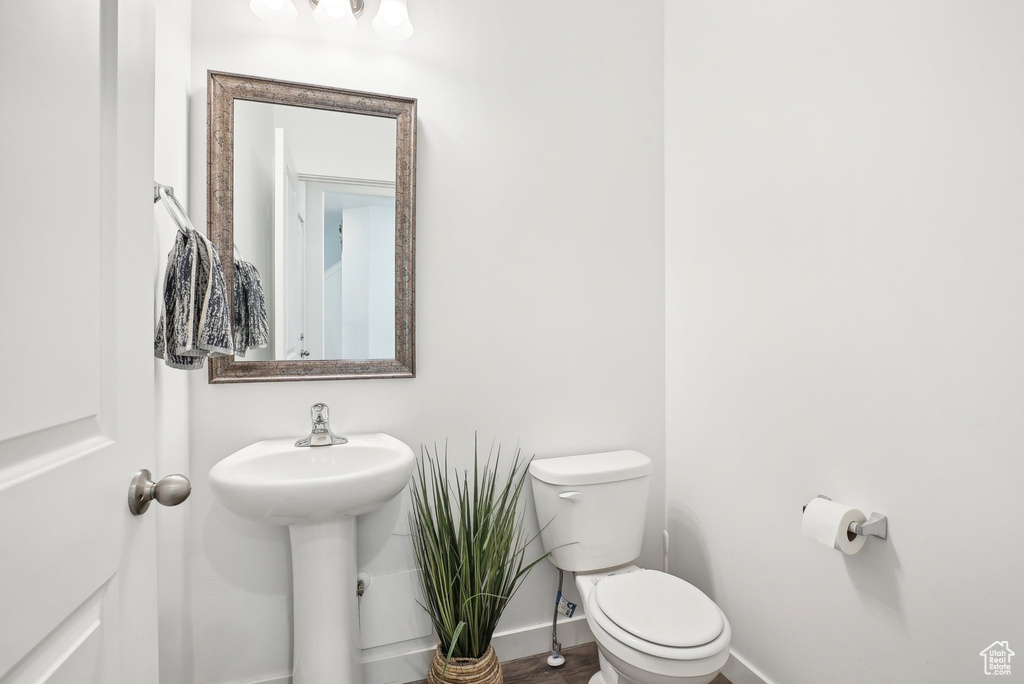 Bathroom featuring baseboards and toilet
