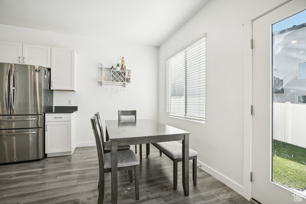 Dining space with baseboards and dark wood-style flooring