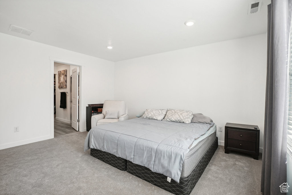 Bedroom with carpet floors, baseboards, and visible vents