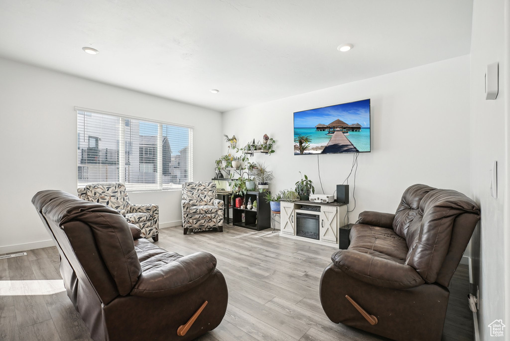 Living area with recessed lighting, baseboards, visible vents, and light wood-style flooring