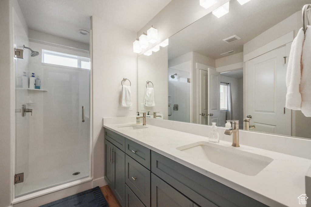 Full bath with a shower stall, a sink, and plenty of natural light