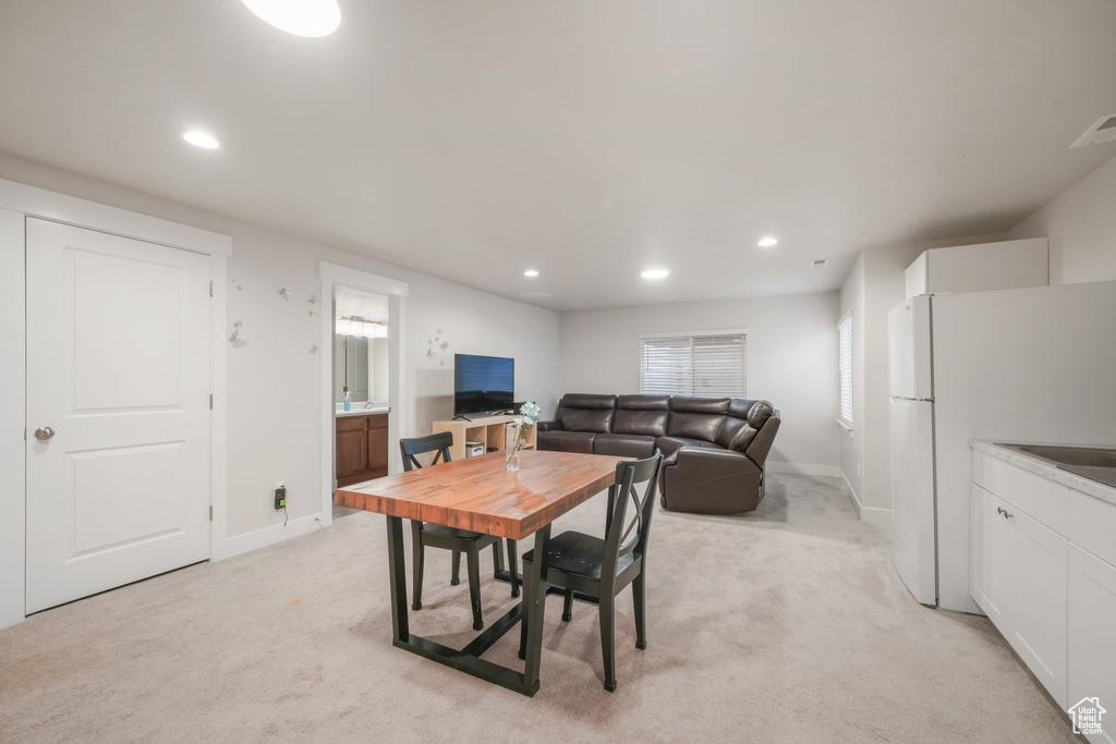 Dining space featuring baseboards, light carpet, and recessed lighting