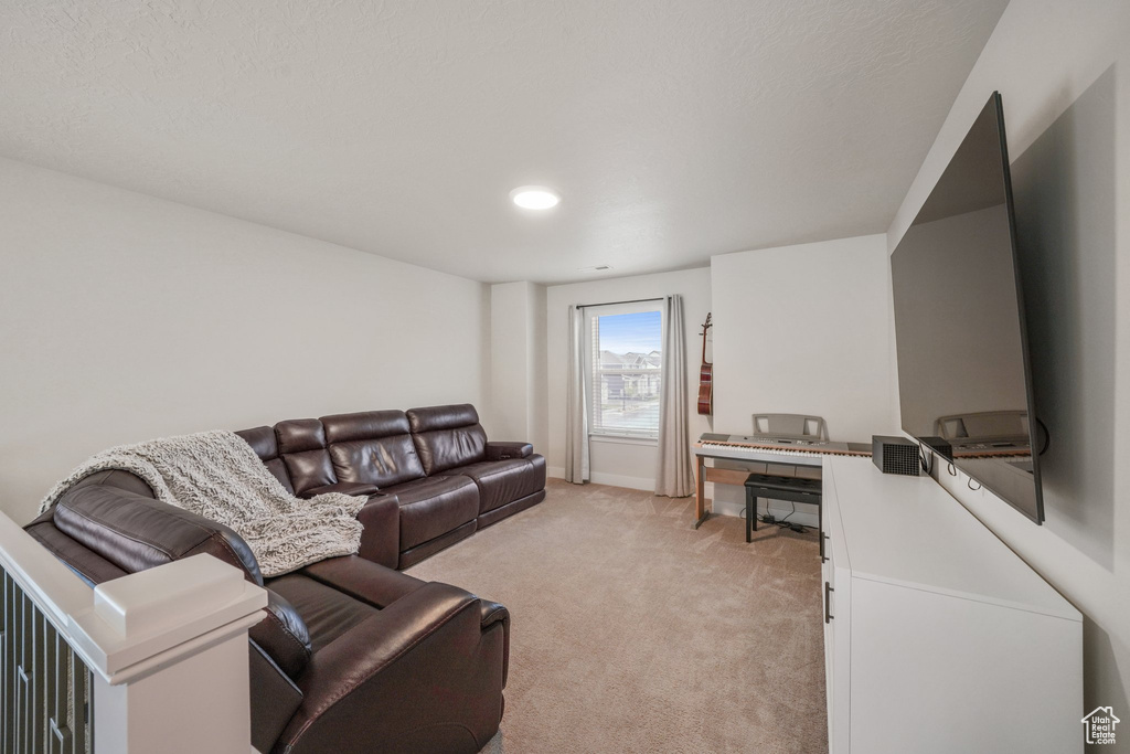 Living room featuring baseboards and light carpet