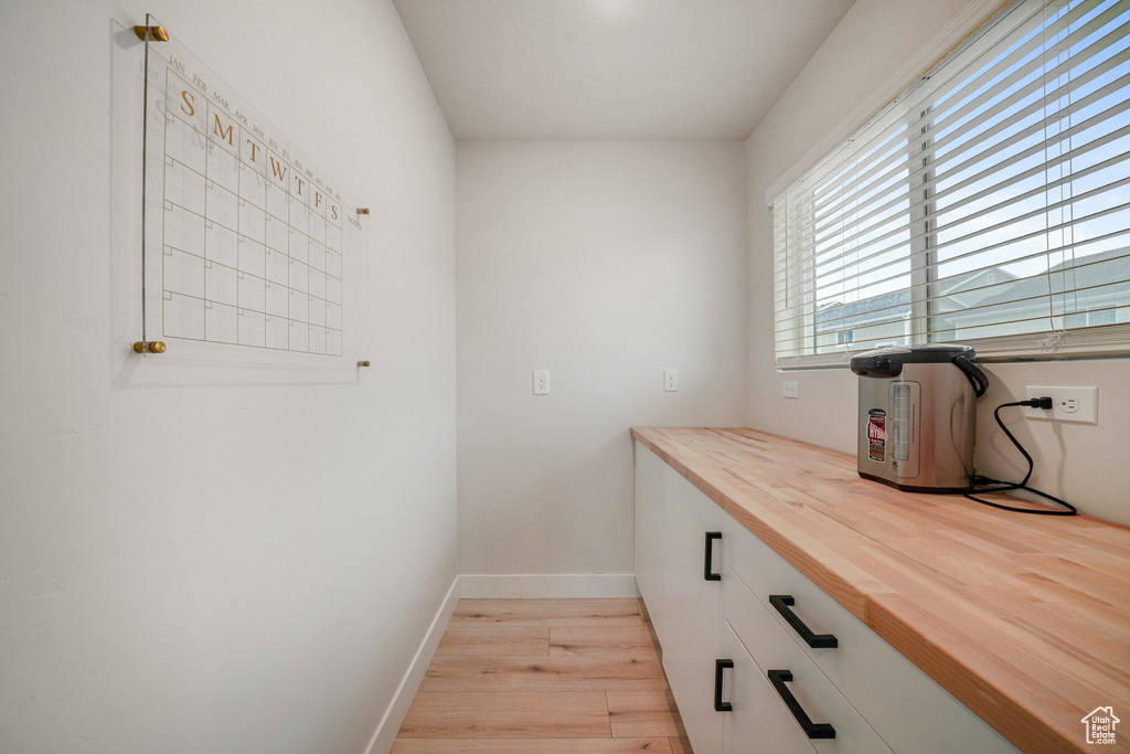 Interior space featuring baseboards and light wood finished floors