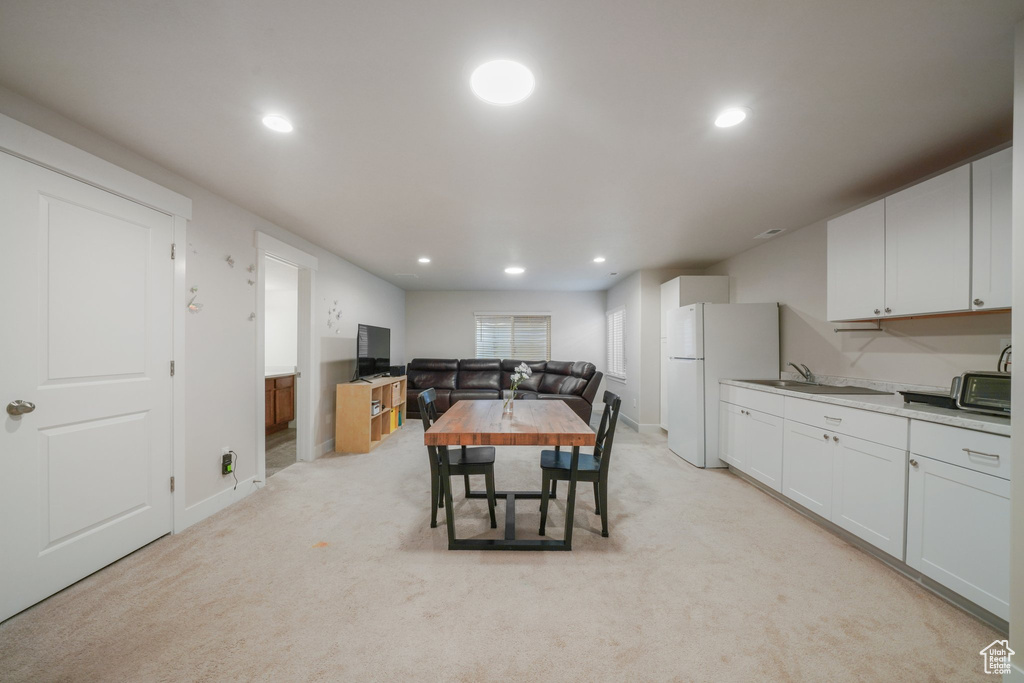 Dining space with light carpet and recessed lighting