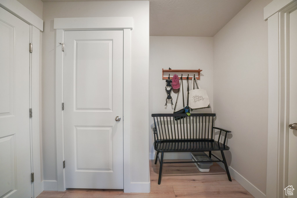 Hall with baseboards and light wood finished floors