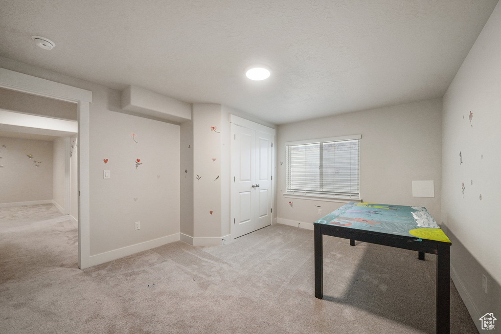 Playroom with light colored carpet and baseboards