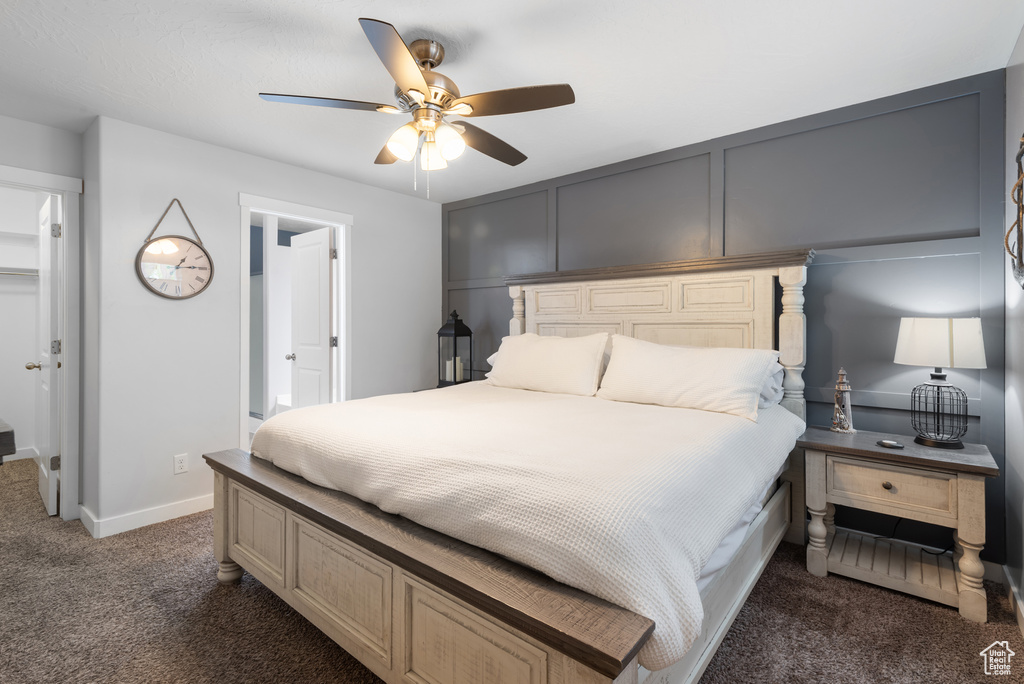 Carpeted bedroom featuring baseboards and a ceiling fan